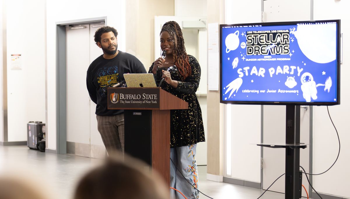 Dr. Raven Baxter and Dr. Ronald Gamble stand at the Buffalo State podium beside a screen reading Stellar Dreams Star Party