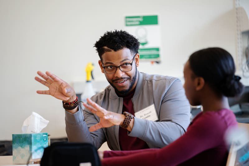 A scientist talks with a student